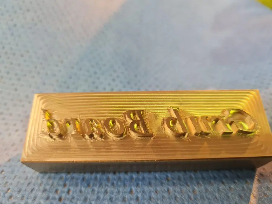 Engraved lettering machined into a brass plate