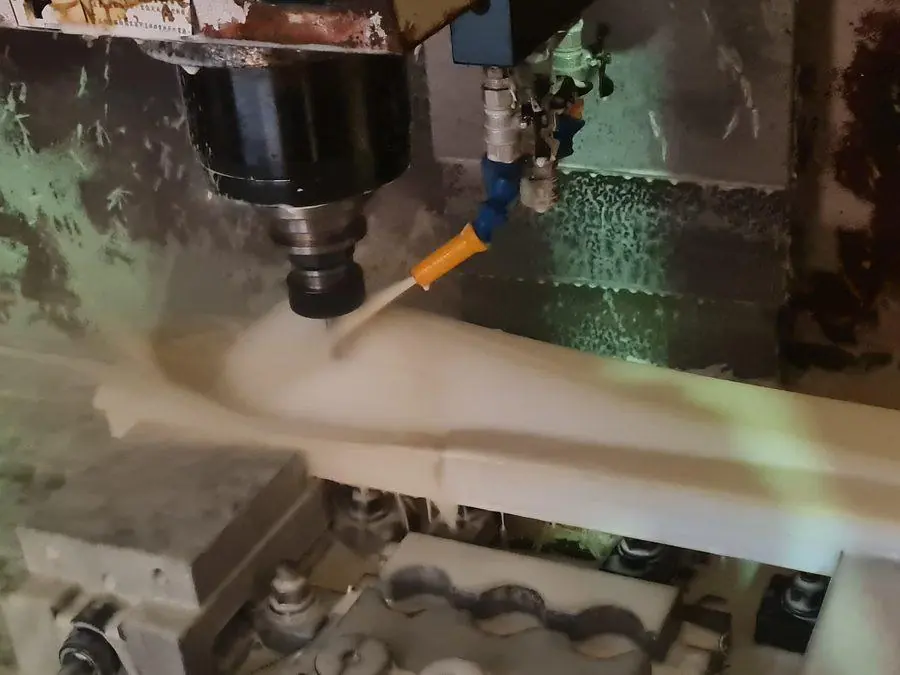 A cutter working through aluminium under flood coolant