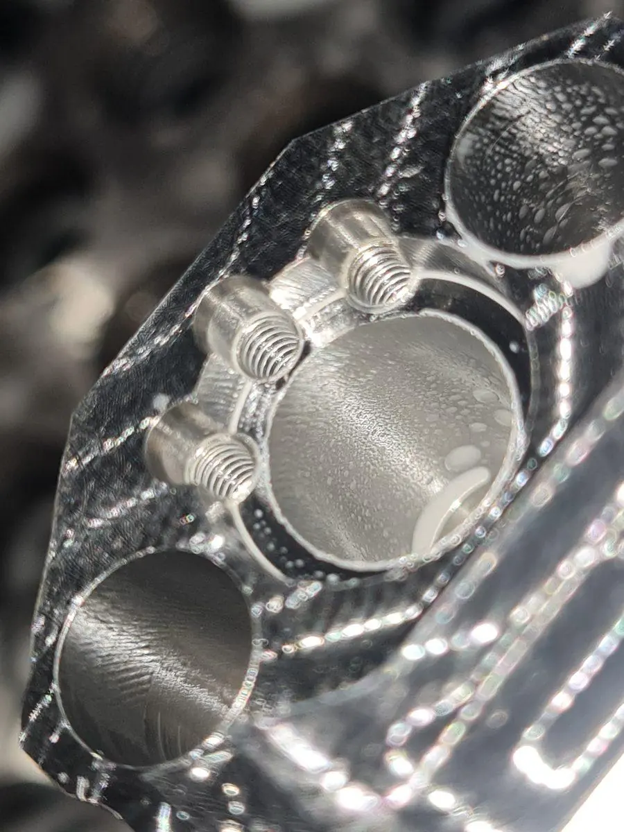 A machined face held up to the light, close in