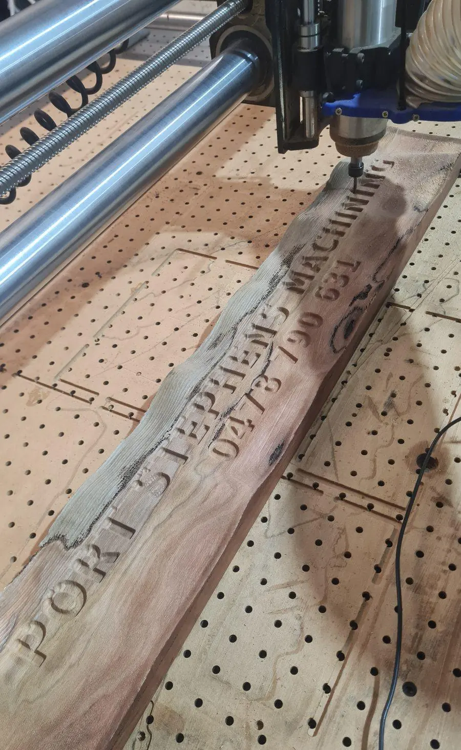 A hardwood sign being carved on the CNC router